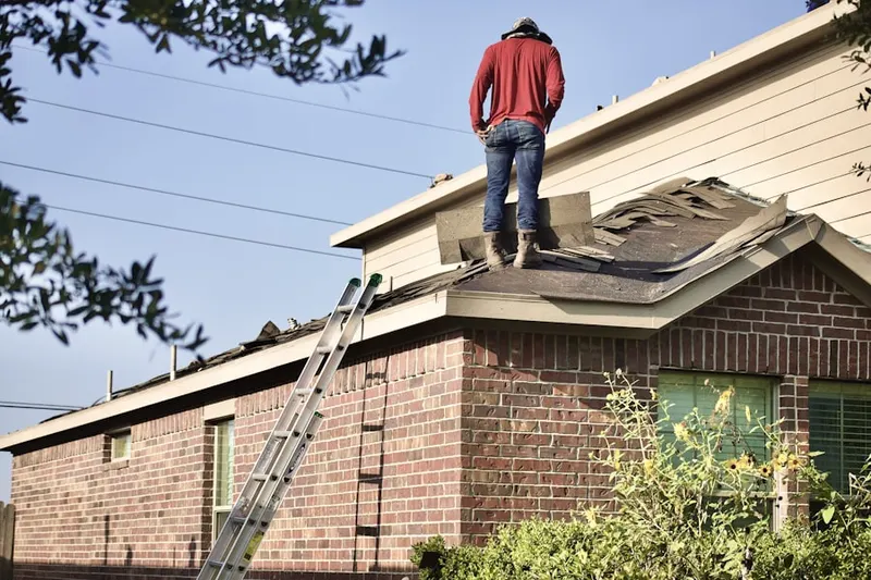 Professional roofer working on a residential roof in Commissary Corner